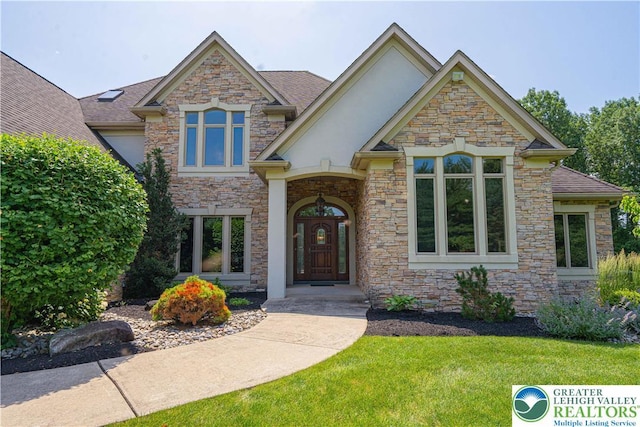 2650 Eagle Ln, Lower Saucon Twp, PA 18055 - craftsman-style house with stucco siding, stone siding, a front yard, and roof with shingles