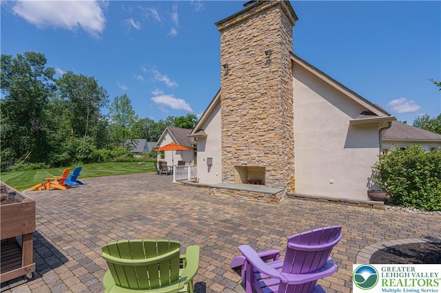 2650 Eagle Ln, Lower Saucon Twp, PA 18055 - view of patio / terrace featuring an outdoor stone fireplace