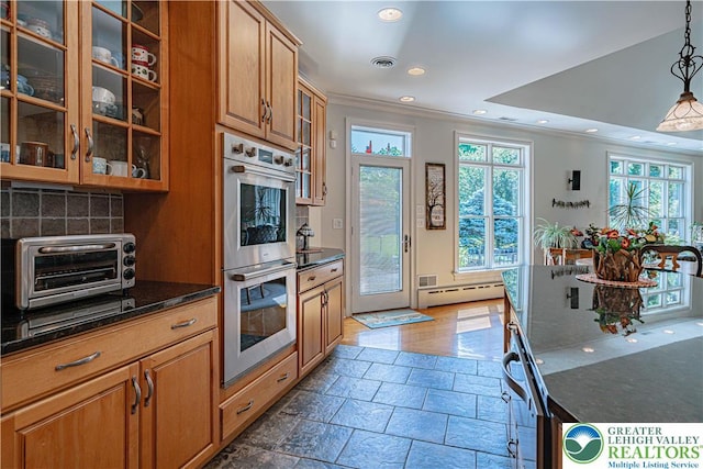 2650 Eagle Ln, Lower Saucon Twp, PA 18055 - kitchen featuring double oven, crown molding, stone tile flooring, recessed lighting, and decorative backsplash