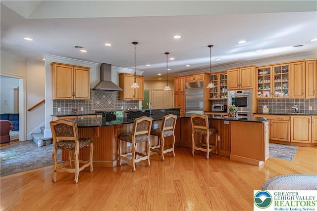 2650 Eagle Ln, Lower Saucon Twp, PA 18055 - kitchen featuring wall chimney exhaust hood, appliances with stainless steel finishes, tasteful backsplash, a spacious island, and recessed lighting