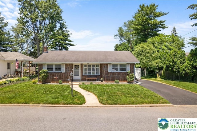 2213 W Woodlawn St, South Whitehall Twp, PA 18104 - view of front facade with brick siding and a chimney