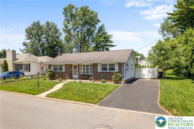 2213 W Woodlawn St, South Whitehall Twp, PA 18104 - view of front facade with driveway, a front yard, and a gate