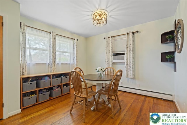 2213 W Woodlawn St, South Whitehall Twp, PA 18104 - dining space with baseboard heating, wood finished floors, cooling unit, and a chandelier