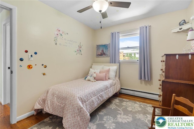 2213 W Woodlawn St, South Whitehall Twp, PA 18104 - bedroom featuring a baseboard heating unit, wood finished floors, and a ceiling fan