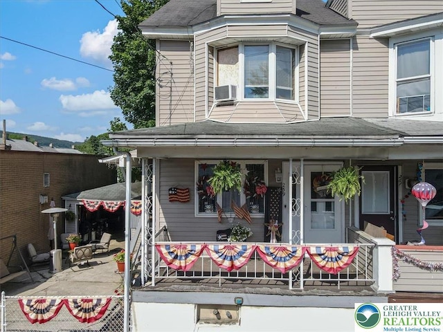 259 5th St, Coaldale Boro, PA 18218 - view of front facade featuring a porch, a shingled roof, and cooling unit
