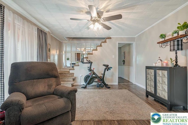 259 5th St, Coaldale Boro, PA 18218 - living area with stairway, a ceiling fan, ornamental molding, wood finished floors, and a wainscoted wall
