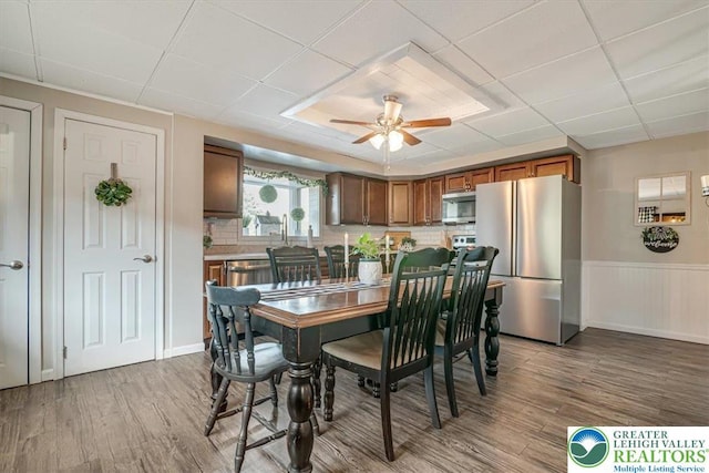 259 5th St, Coaldale Boro, PA 18218 - dining space with ceiling fan, wood finished floors, wainscoting, and a drop ceiling