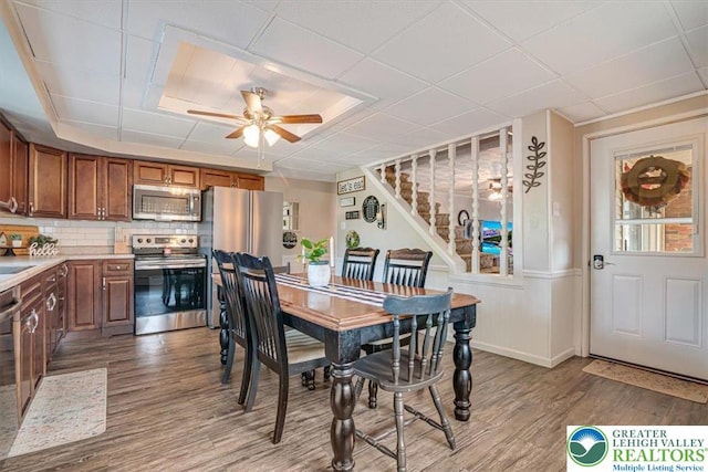 259 5th St, Coaldale Boro, PA 18218 - dining area featuring wood finished floors, a ceiling fan, and stairs