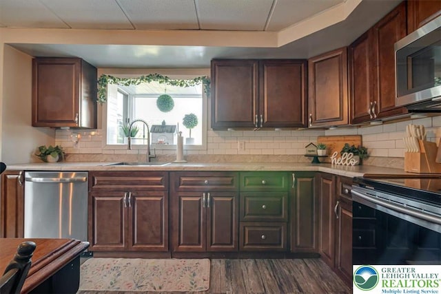 259 5th St, Coaldale Boro, PA 18218 - kitchen with stainless steel appliances, light countertops, dark wood-style flooring, decorative backsplash, and dark brown cabinetry