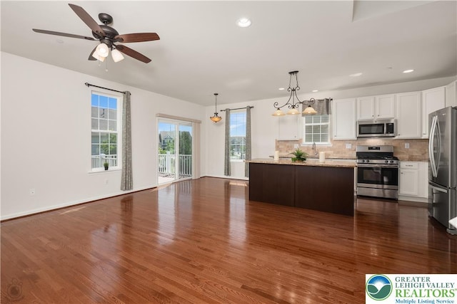 4618 Woodbrush Way, Upper Macungie Twp, PA 18104 - kitchen with appliances with stainless steel finishes, white cabinetry, backsplash, dark wood-style flooring, and light stone countertops