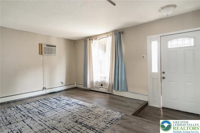 2103 N 1st Ave, Whitehall Twp, PA 18052 - entrance foyer featuring wood finished floors, a wall unit AC, and a baseboard radiator