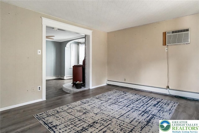 2103 N 1st Ave, Whitehall Twp, PA 18052 - unfurnished room featuring a baseboard radiator, wood finished floors, a wall mounted air conditioner, and arched walkways