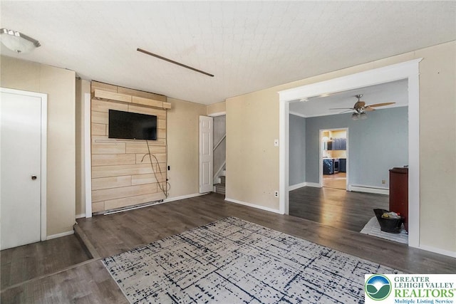 2103 N 1st Ave, Whitehall Twp, PA 18052 - unfurnished living room featuring baseboard heating, ceiling fan, wood finished floors, and stairs