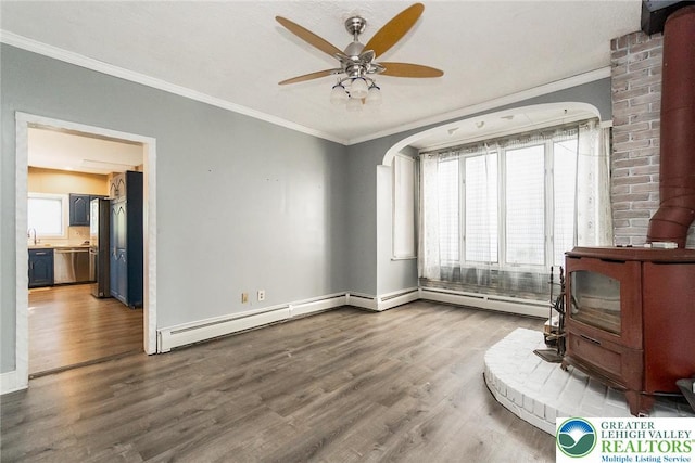 2103 N 1st Ave, Whitehall Twp, PA 18052 - bedroom with a wood stove, ornamental molding, wood finished floors, and a baseboard radiator