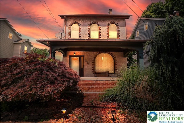 2103 N 1st Ave, Whitehall Twp, PA 18052 - view of front of property with brick siding, covered porch, and a chimney