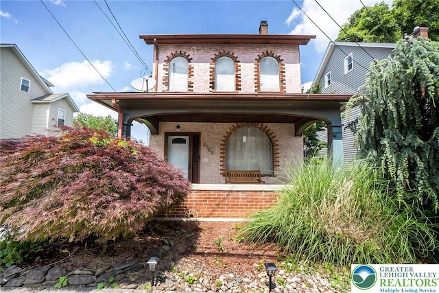2103 N 1st Ave, Whitehall Twp, PA 18052 - view of front of home featuring brick siding, a chimney, and covered porch