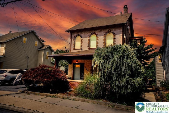 2103 N 1st Ave, Whitehall Twp, PA 18052 - view of front of property featuring brick siding, a chimney, and a shingled roof