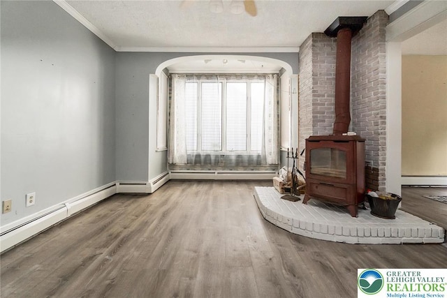 2103 N 1st Ave, Whitehall Twp, PA 18052 - unfurnished living room with a wood stove, wood finished floors, a baseboard radiator, and crown molding