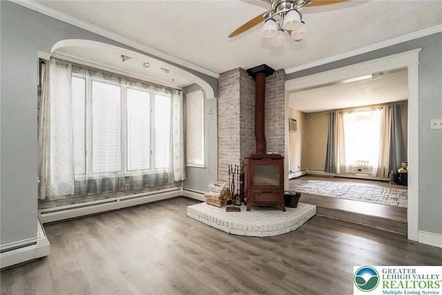 2103 N 1st Ave, Whitehall Twp, PA 18052 - living area with ornamental molding, a wood stove, ceiling fan, wood finished floors, and baseboard heating