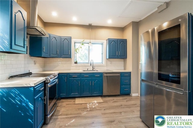 2103 N 1st Ave, Whitehall Twp, PA 18052 - kitchen featuring appliances with stainless steel finishes, range hood, blue cabinetry, and recessed lighting