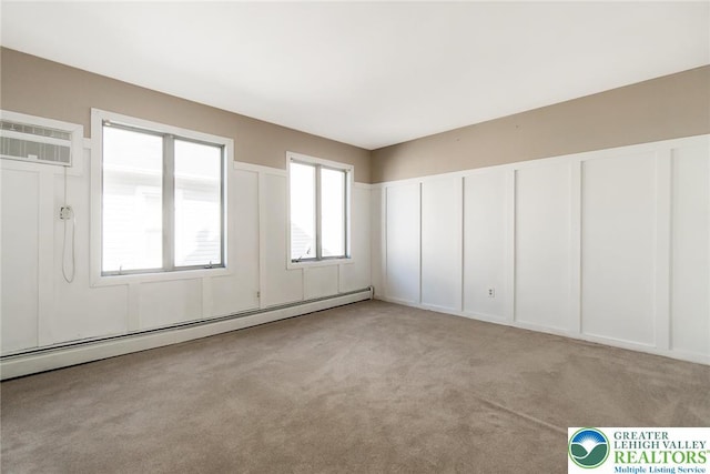 2103 N 1st Ave, Whitehall Twp, PA 18052 - spare room featuring a baseboard heating unit, a wall unit AC, and light colored carpet