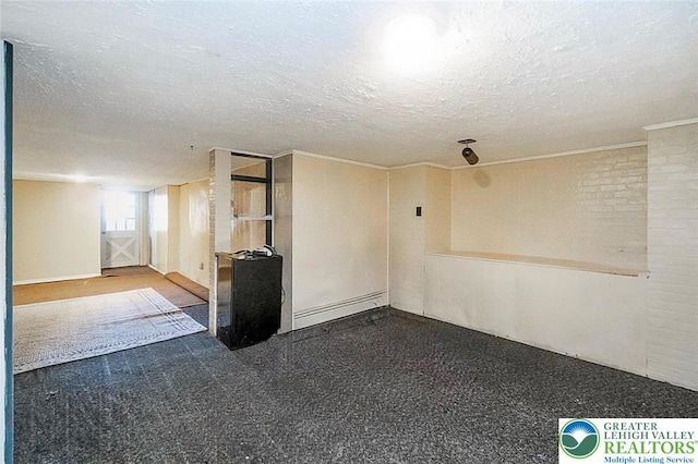 2103 N 1st Ave, Whitehall Twp, PA 18052 - unfurnished room with baseboard heating, a textured ceiling, and ornamental molding