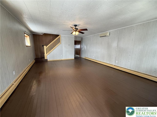 432 3rd St, Lehighton Boro, PA 18235 - unfurnished living room featuring baseboard heating, ceiling fan, stairway, a wall unit AC, and hardwood / wood-style floors