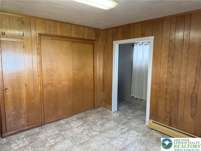 432 3rd St, Lehighton Boro, PA 18235 - empty room with a baseboard heating unit and wood walls