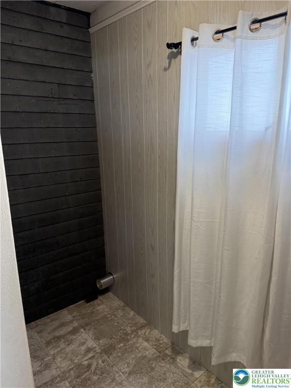 432 3rd St, Lehighton Boro, PA 18235 - full bathroom with wood walls and a shower with shower curtain