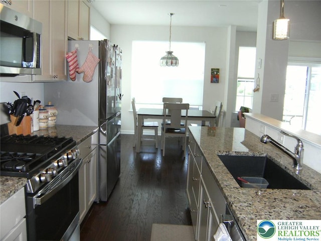 4088 Eveningstar Rd, Emmaus Boro, PA 18049 - kitchen featuring stainless steel appliances, dark wood finished floors, hanging light fixtures, and light stone countertops