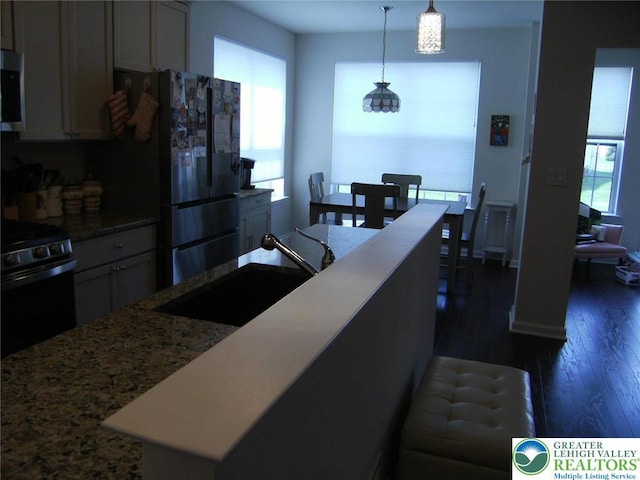 4088 Eveningstar Rd, Emmaus Boro, PA 18049 - kitchen with stove, freestanding refrigerator, dark wood finished floors, stainless steel microwave, and light stone countertops