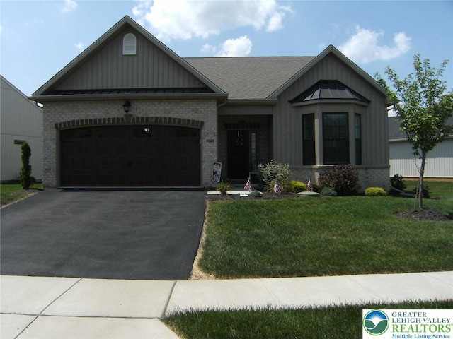 4088 Eveningstar Rd, Emmaus Boro, PA 18049 - view of front of property with board and batten siding, asphalt driveway, an attached garage, a front yard, and brick siding