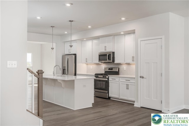 1022 Watson Ct, Upper Macungie Twp, PA 18051 - kitchen with stainless steel appliances, decorative backsplash, dark wood-type flooring, white cabinetry, and recessed lighting