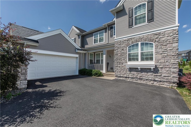 2835 Lenape, Forks Twp, PA 18040 - view of front of house with stone siding, covered porch, driveway, and an attached garage