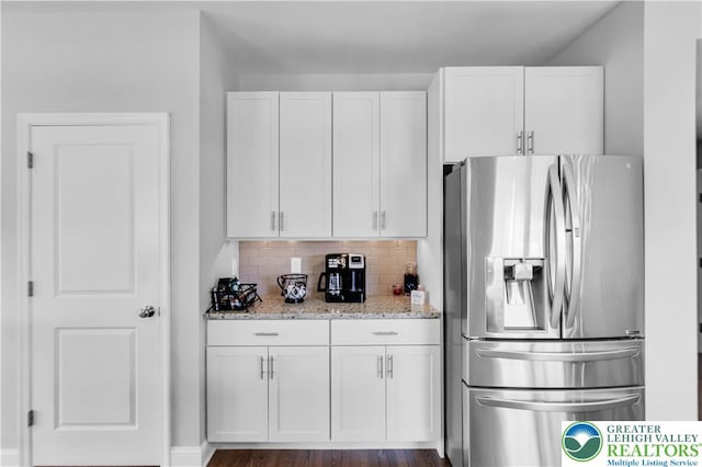 2835 Lenape, Forks Twp, PA 18040 - kitchen featuring stainless steel refrigerator with ice dispenser, white cabinets, light stone countertops, and decorative backsplash