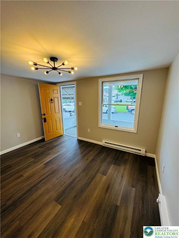 332 W Patterson St, Lansford Boro, PA 18232 - spare room featuring a baseboard heating unit, a chandelier, dark wood-style floors, and baseboard heating