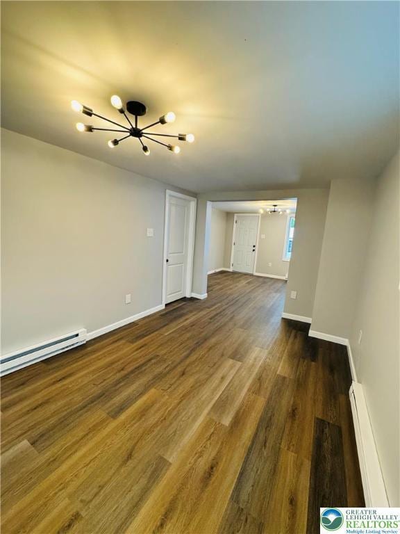 332 W Patterson St, Lansford Boro, PA 18232 - unfurnished living room with a chandelier, a baseboard radiator, and dark wood-type flooring