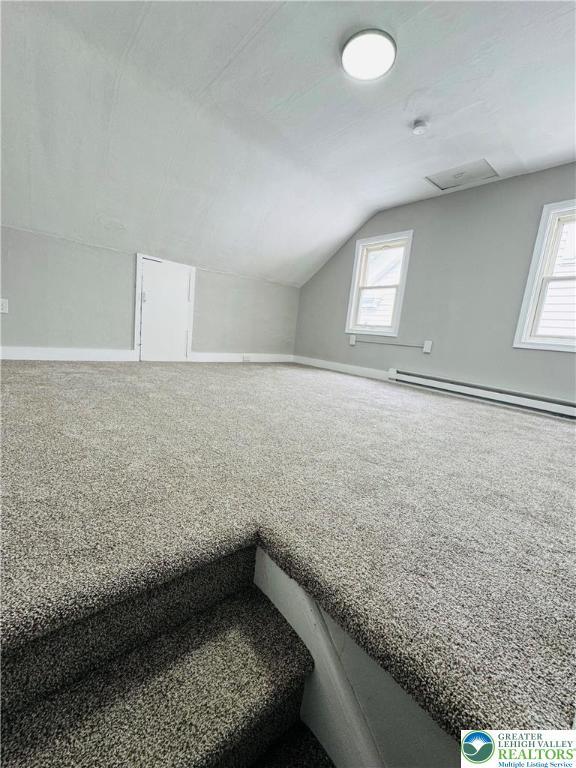 332 W Patterson St, Lansford Boro, PA 18232 - additional living space with baseboard heating, vaulted ceiling, and carpet flooring