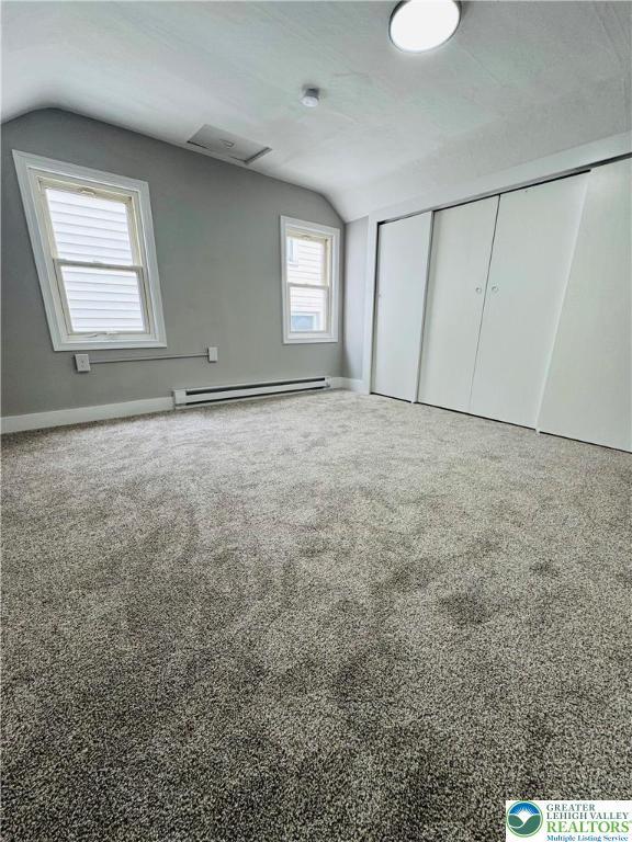 332 W Patterson St, Lansford Boro, PA 18232 - unfurnished bedroom featuring vaulted ceiling, a baseboard radiator, a closet, and carpet