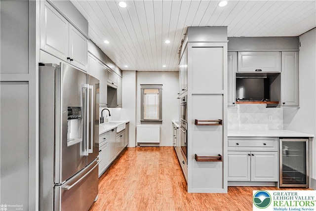 4711 Main St, Whitehall Twp, PA 18052 - kitchen featuring high quality fridge, wine cooler, recessed lighting, light countertops, and light wood finished floors