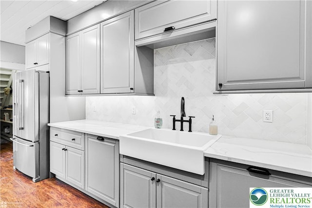 4711 Main St, Whitehall Twp, PA 18052 - kitchen featuring high end fridge, tasteful backsplash, gray cabinets, and wood finished floors