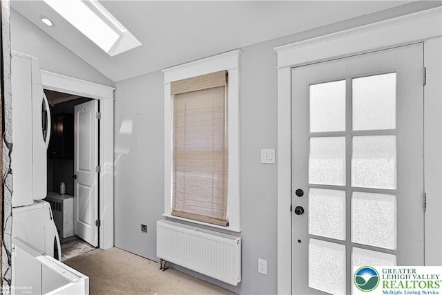 4711 Main St, Whitehall Twp, PA 18052 - doorway featuring stacked washing machine and dryer, radiator heating unit, lofted ceiling, and a skylight