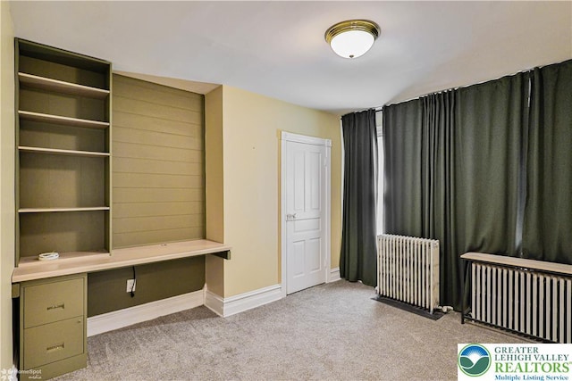 4711 Main St, Whitehall Twp, PA 18052 - unfurnished bedroom with radiator heating unit, carpet flooring, and built in desk