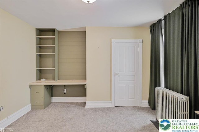 4711 Main St, Whitehall Twp, PA 18052 - unfurnished office featuring radiator heating unit, carpet, and built in desk