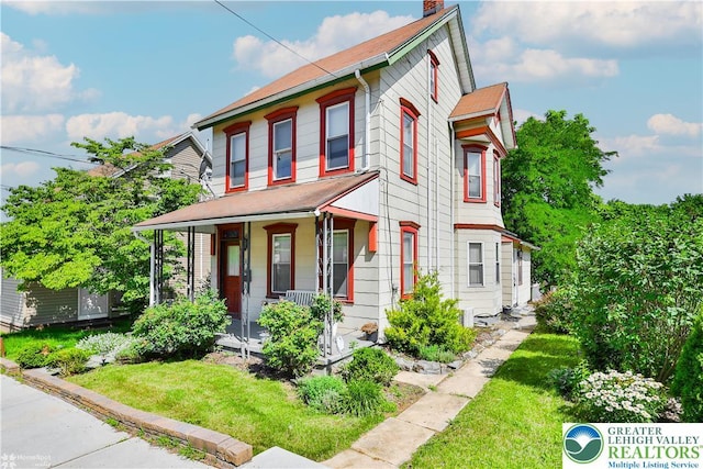 4711 Main St, Whitehall Twp, PA 18052 - view of front of home with a porch, a chimney, and a front yard