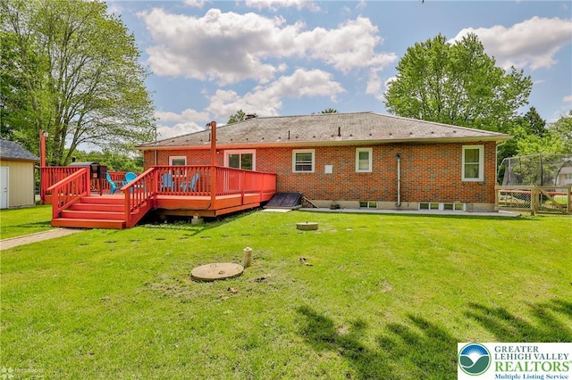 236 Moorestown Rd, Bushkill Twp, PA 18091 - back of house featuring a deck, a lawn, and brick siding