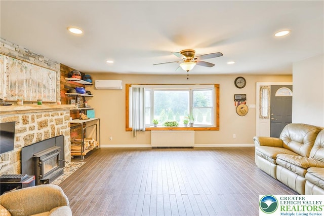 236 Moorestown Rd, Bushkill Twp, PA 18091 - living area with radiator, a wall mounted AC, ceiling fan, wood finished floors, and recessed lighting
