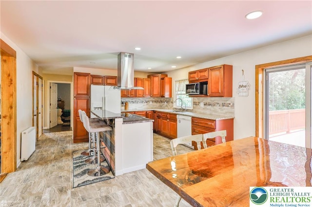 236 Moorestown Rd, Bushkill Twp, PA 18091 - kitchen featuring extractor fan, white appliances, a center island, backsplash, and a kitchen bar