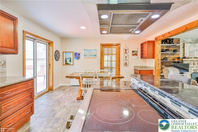 236 Moorestown Rd, Bushkill Twp, PA 18091 - kitchen with light stone counters, brown cabinetry, recessed lighting, and electric range oven