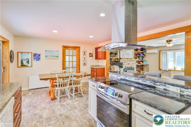 236 Moorestown Rd, Bushkill Twp, PA 18091 - kitchen with electric range, radiator heating unit, island range hood, dark stone countertops, and recessed lighting
